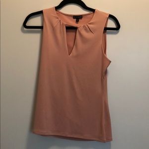 A sleeveless blush too with key hole by Express.